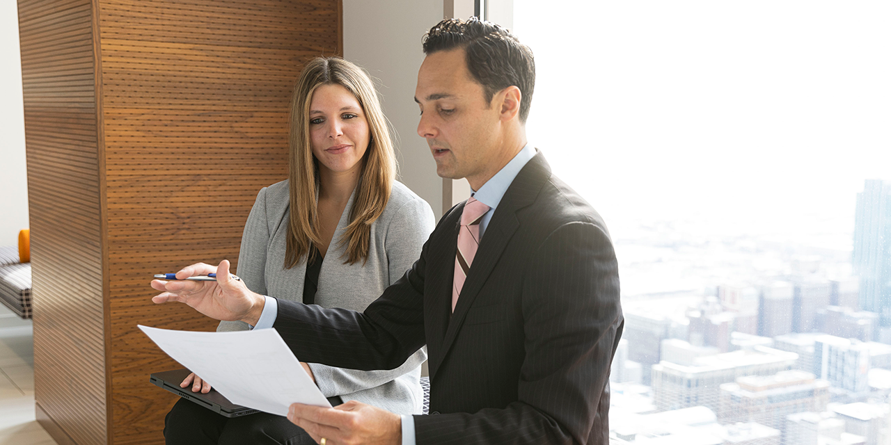  Silver LakeFixed Income Capital Markets associates talking in front of a window in Chicago