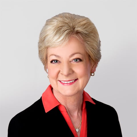 Kim Fleming professional headshot with gray background.