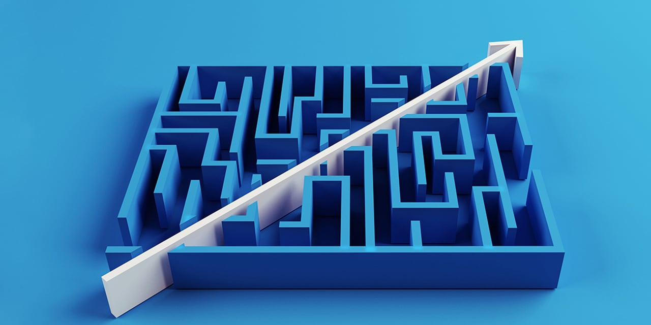 A blue wooden maze with a white arrow cutting through the center of the area in a diagonal direction.